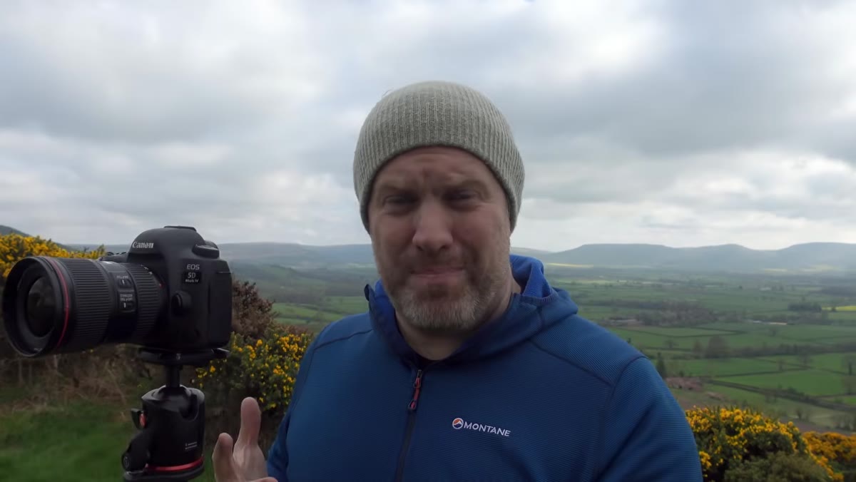 Adam walking through woodland, speaking to camera about photography philosophy