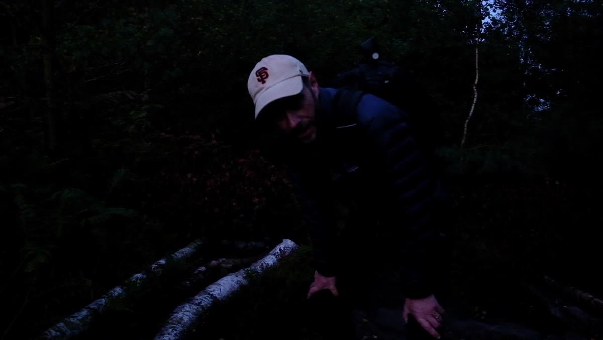 Nigel moving toward the hilltop, camera still in bag