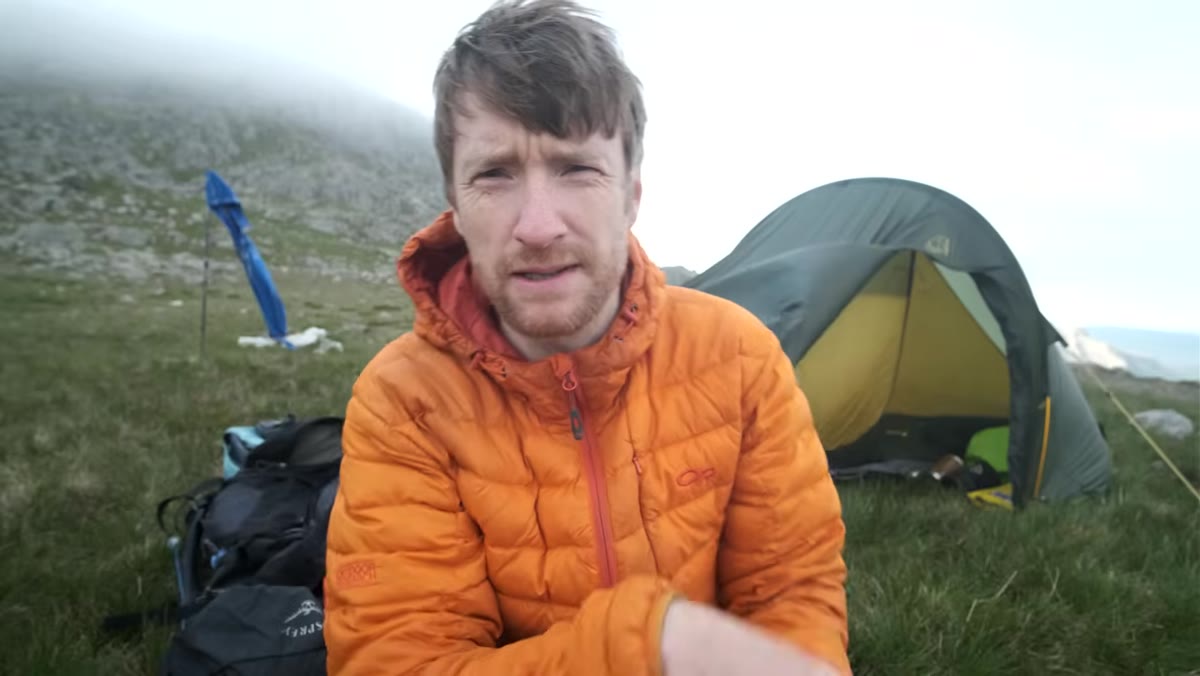 Tent pitched and camp organized in mountain location at dusk