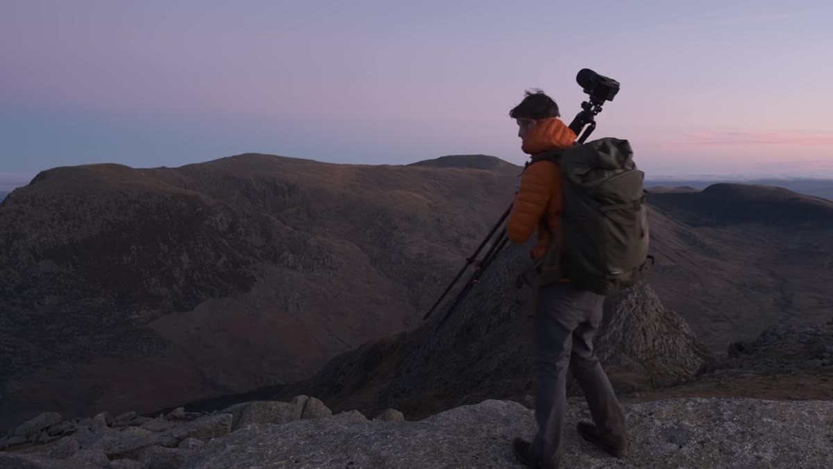 Heaton moving to a new position along a rocky scramble ridge