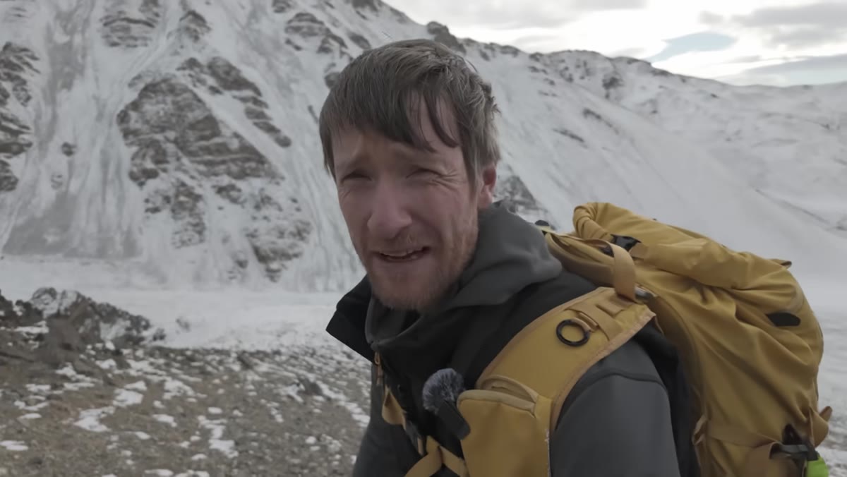Heaton hiking uphill on loose scree at altitude