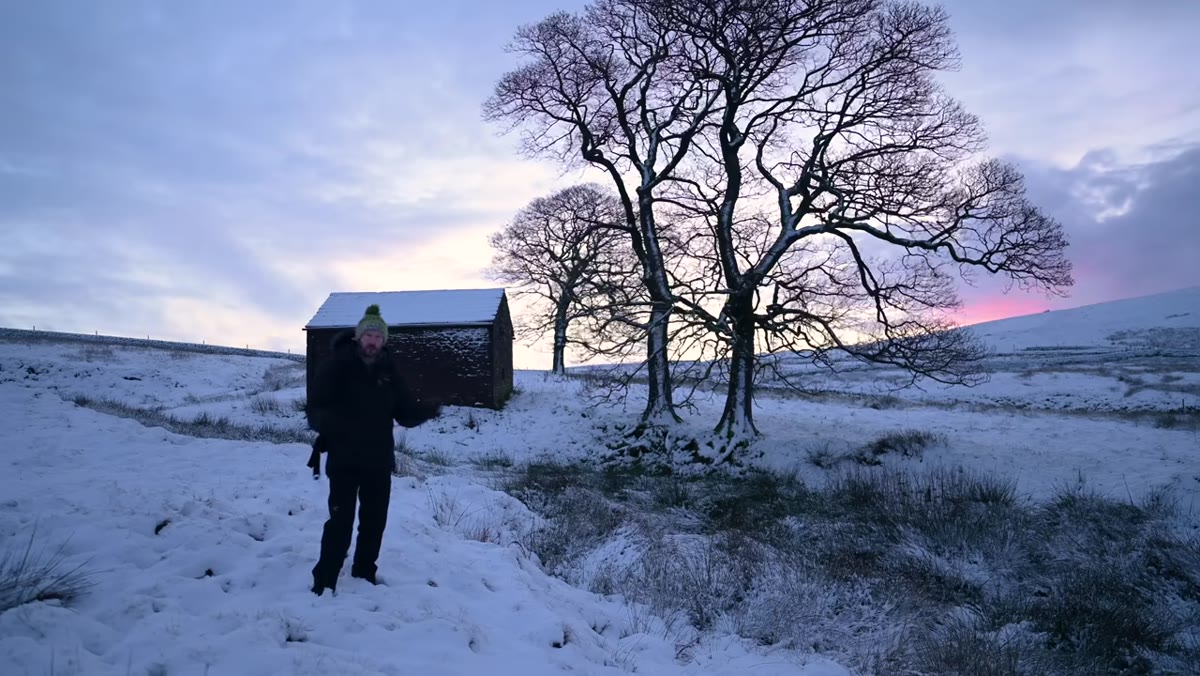 Danson carefully positioning himself to avoid footprints in clean snow