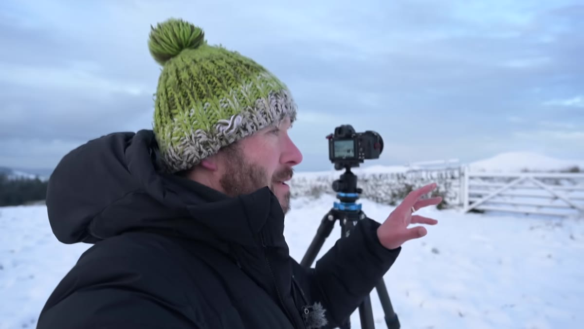 Danson reviewing exposure on camera LCD in snowy field