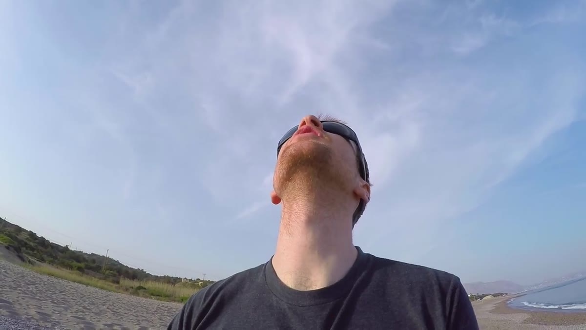 Drone descends closer, umbrellas fill the entire frame