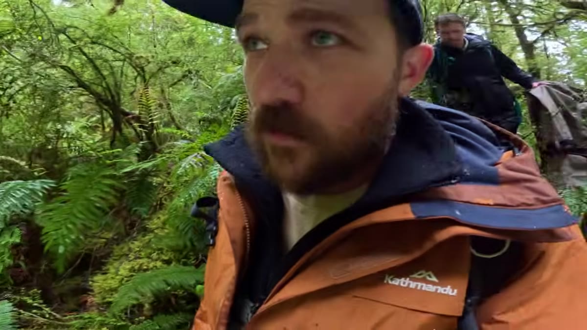 Photographer evaluating an 8-foot drop before climbing down