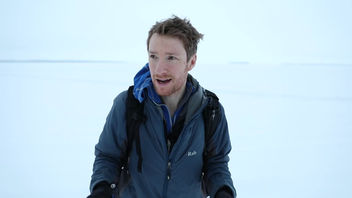 Heaton standing in grey flat landscape describing the challenge