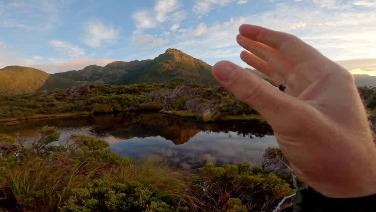 Patino framing a mountain reflection in still water