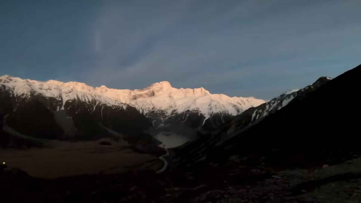 First dawn light on the mountain above camp