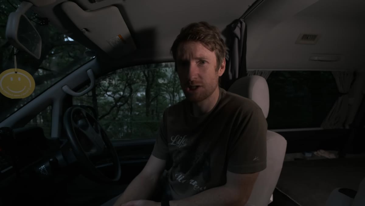 Van parked behind reservoir in dim evening light