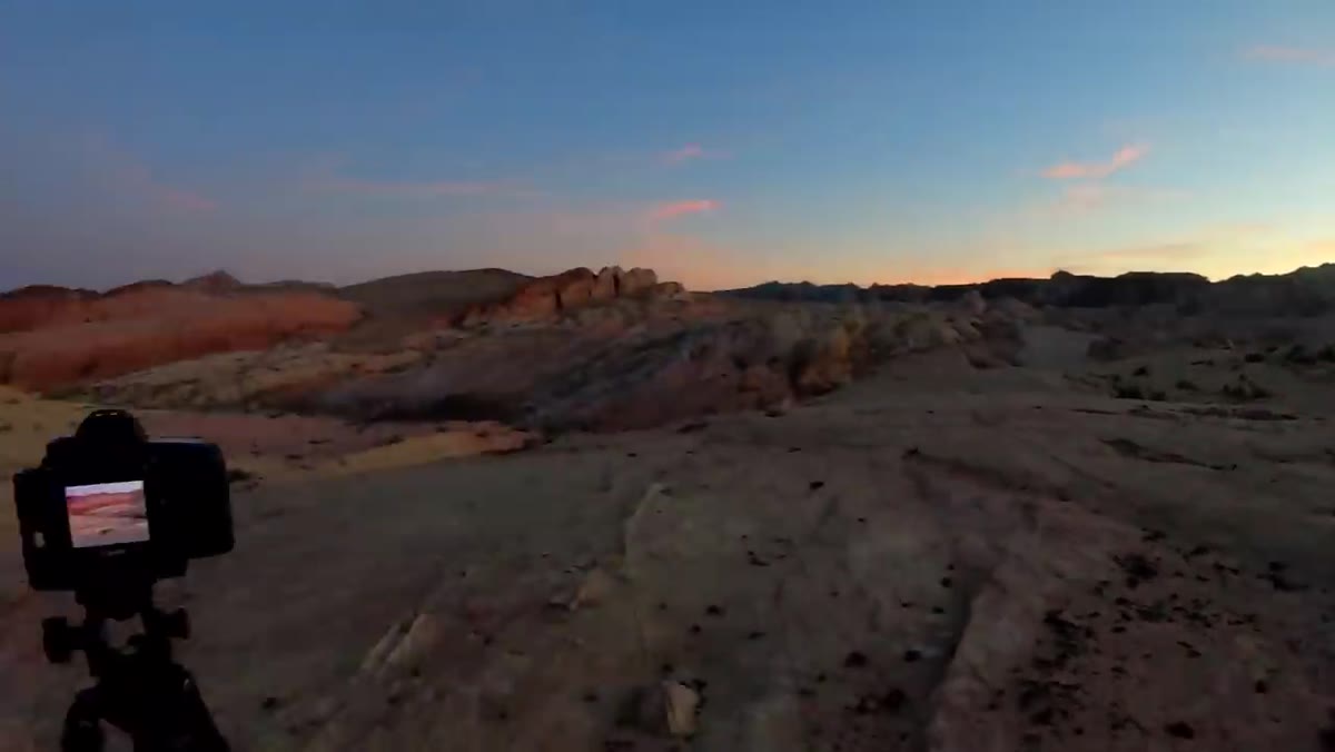 Purple and orange sky reflecting warm tones across canyon rock