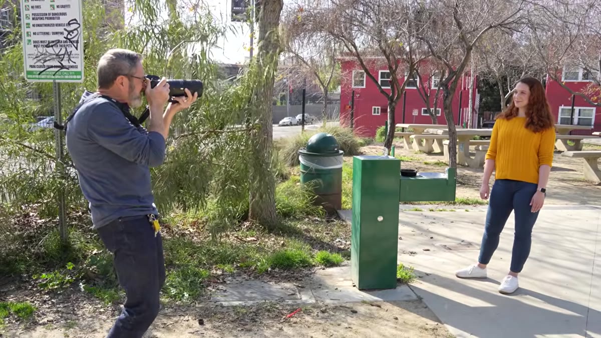 Photographer circling stationary subject, testing different background compositions