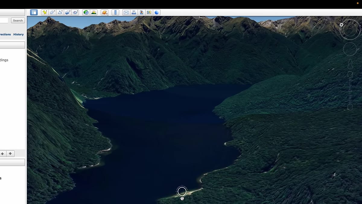 Google Earth showing beach on lake shore below mountain range
