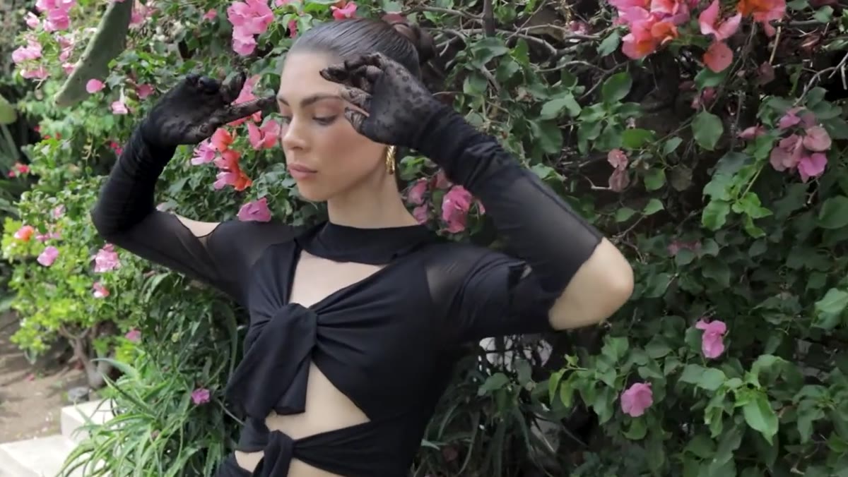 Subject raises hands and adjusts chin angle on photographer&rsquo;s direction
