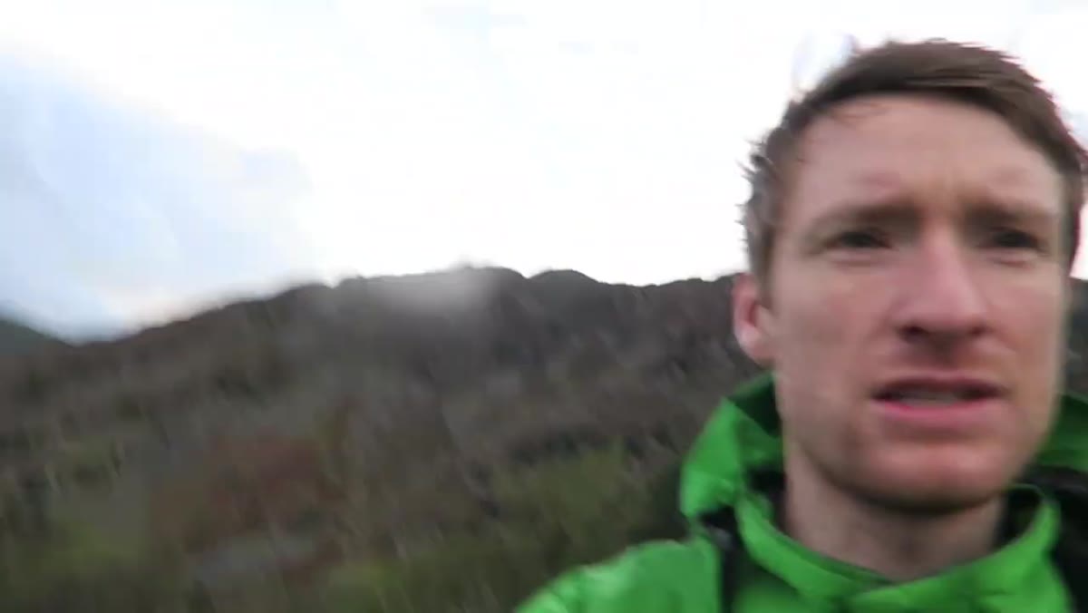 Heaton turning camera toward dramatic light and sky behind him