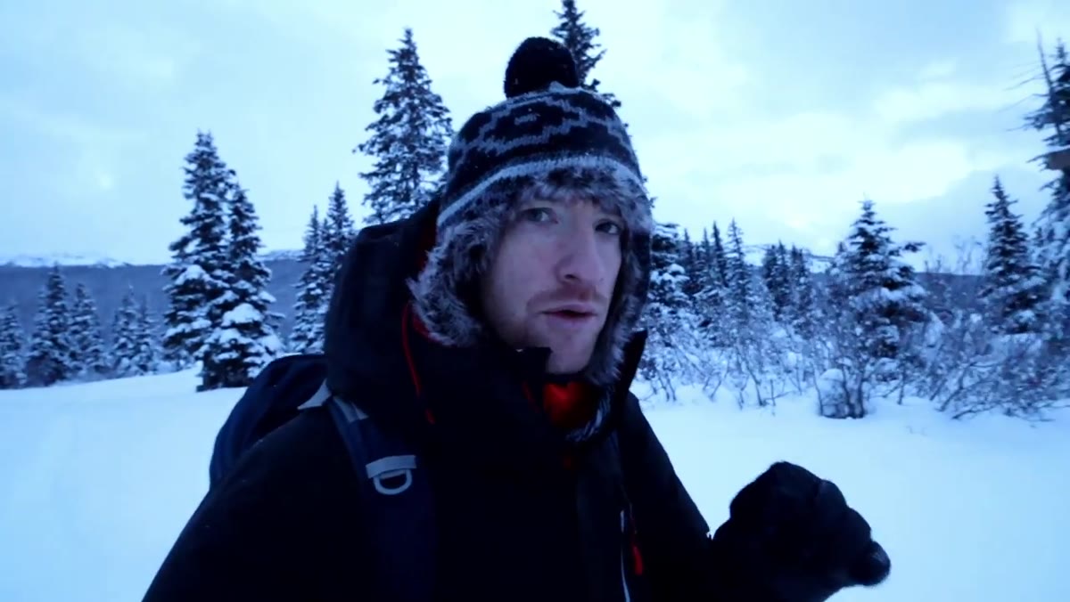 Thomas scanning snow-covered lake and tree line