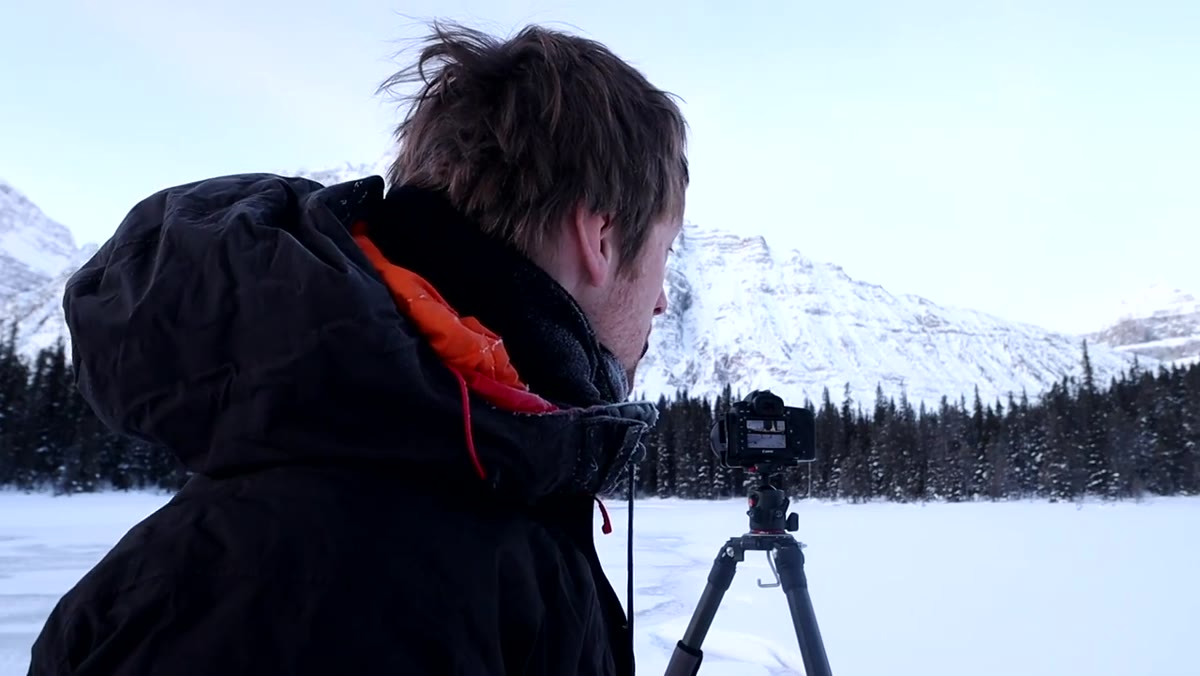 Thomas Heaton checking camera screen for highlight exposure on peak