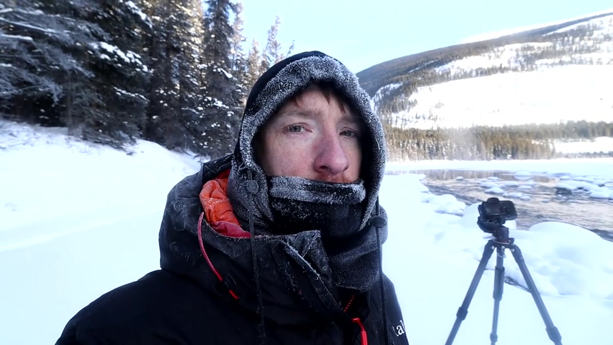 Heaton studying rocky stream area, visibly uncertain about composition