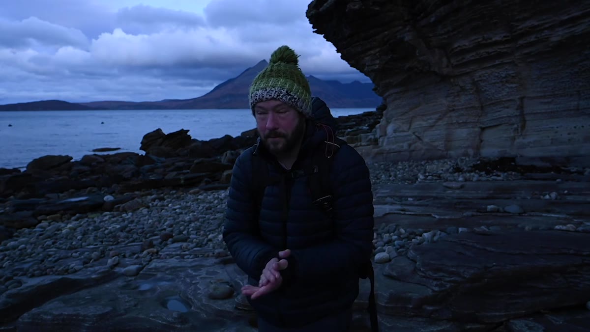 Nigel talking to camera, visibly tired, pre-sunrise light behind him