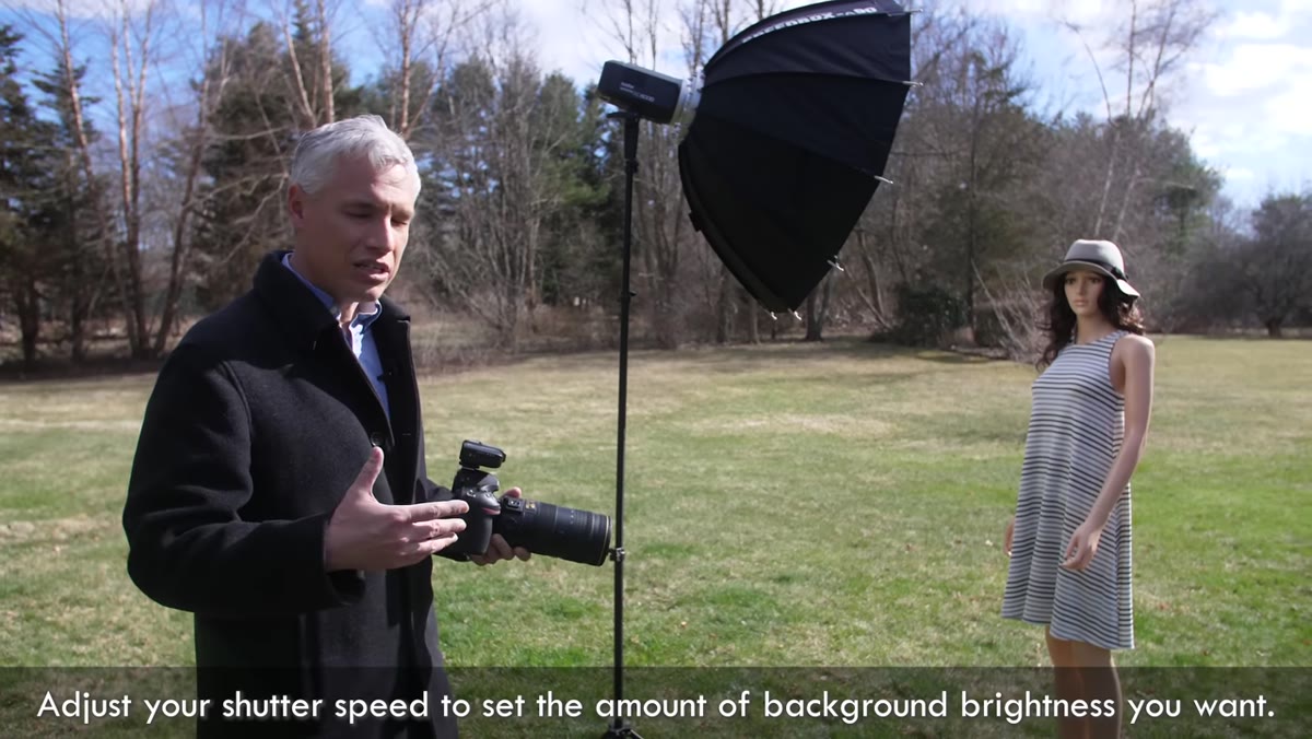 Photographer adjusting shutter speed dial on camera
