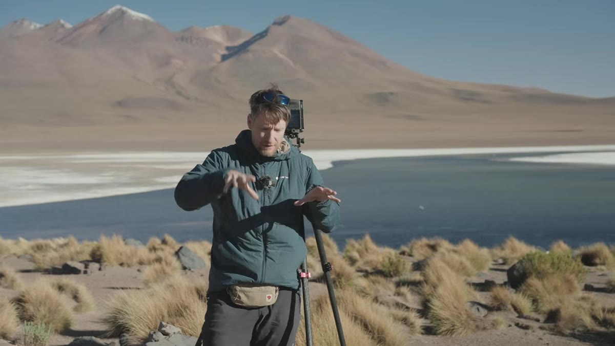 Heaton adjusting position low among grasses, checking lower frame third