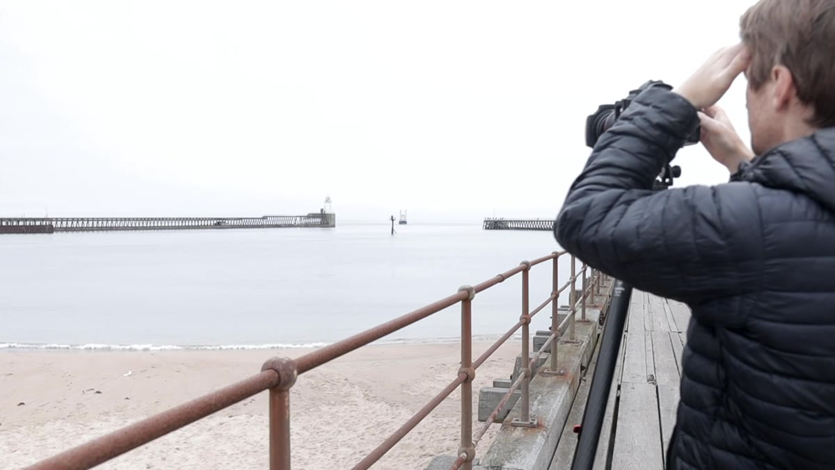 Ship visible in background moving between pier end and groyne