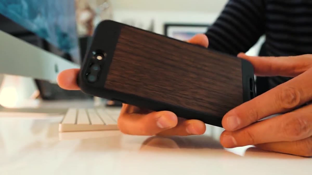 Walnut wood trim Moment case held up to camera