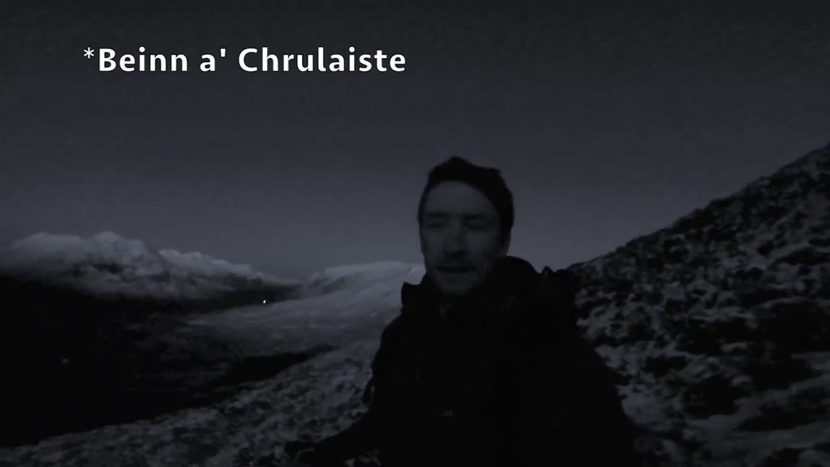 Heaton on a mountain ridge before sunrise over Glencoe valley