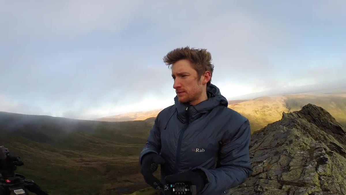 Heaton framing a vertical shot of Sharp Edge disappearing into cloud