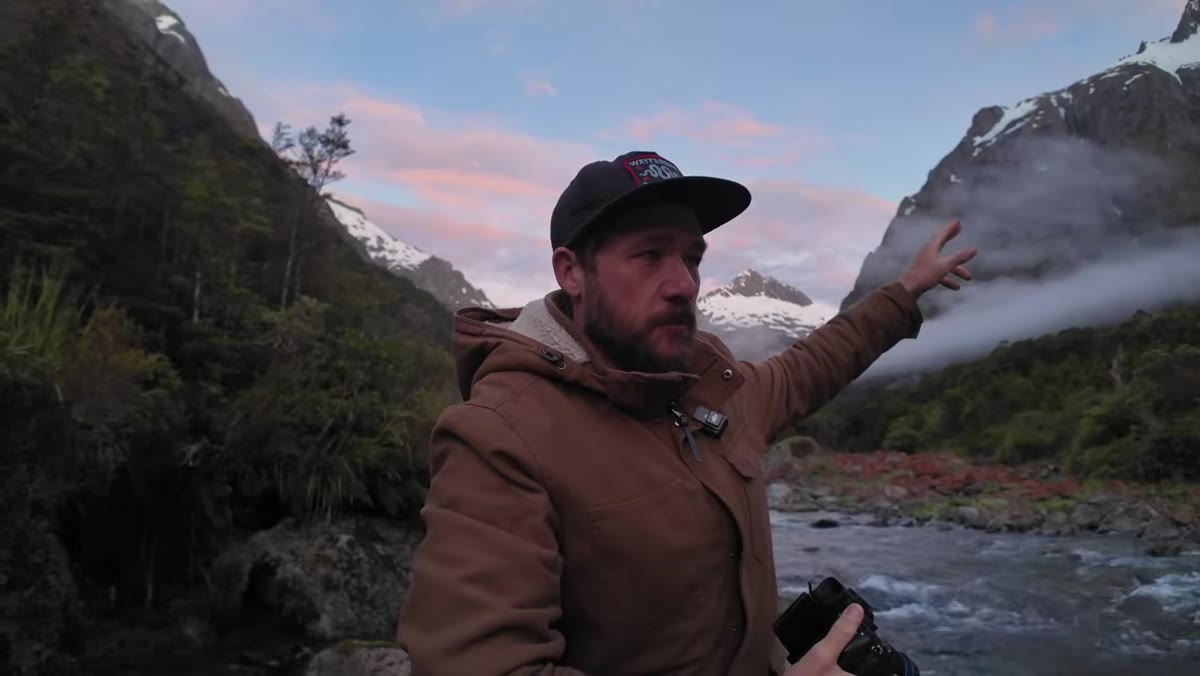 Photographer turning to face opposite peak as sunrise light shifts direction