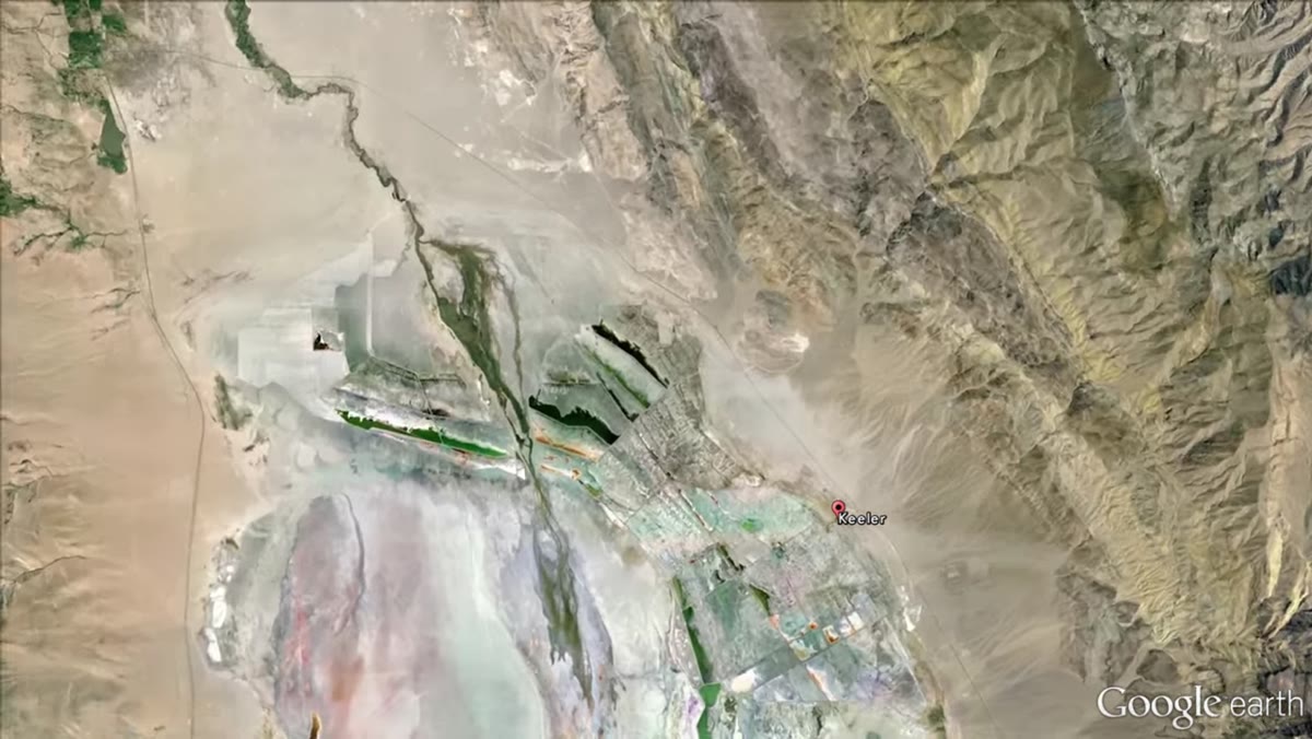 Wide shot of Keeler ghost town, abandoned homes visible in the landscape