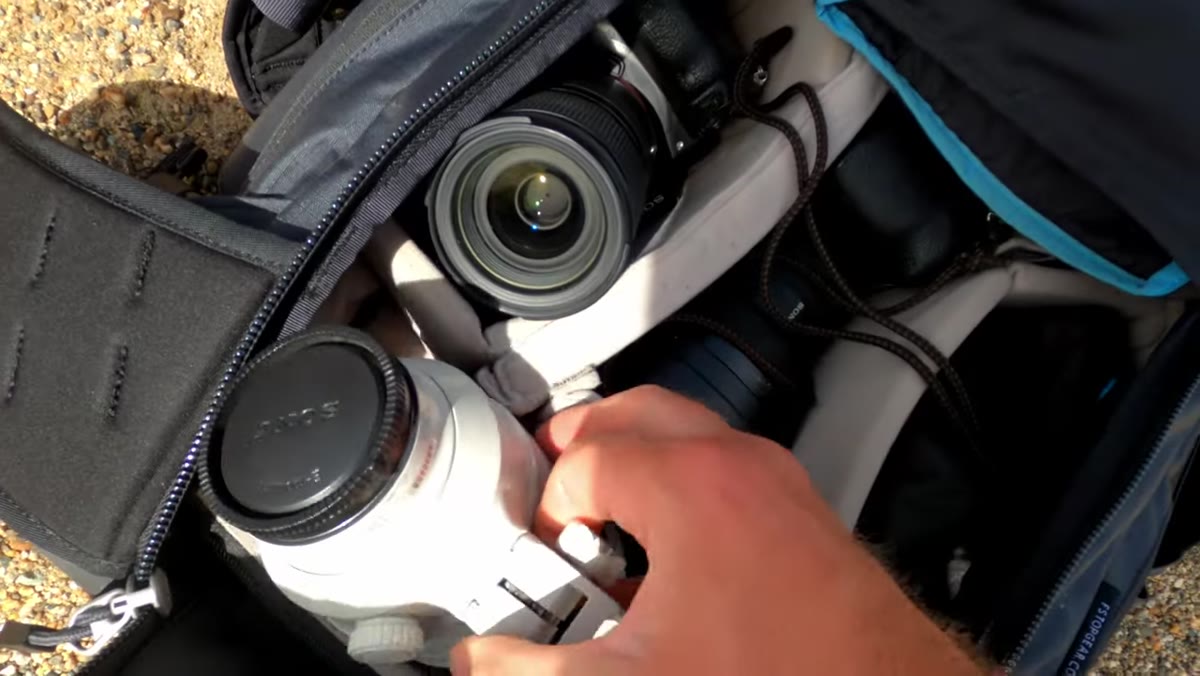 Patino choosing between 100-400mm and 28-75mm lenses