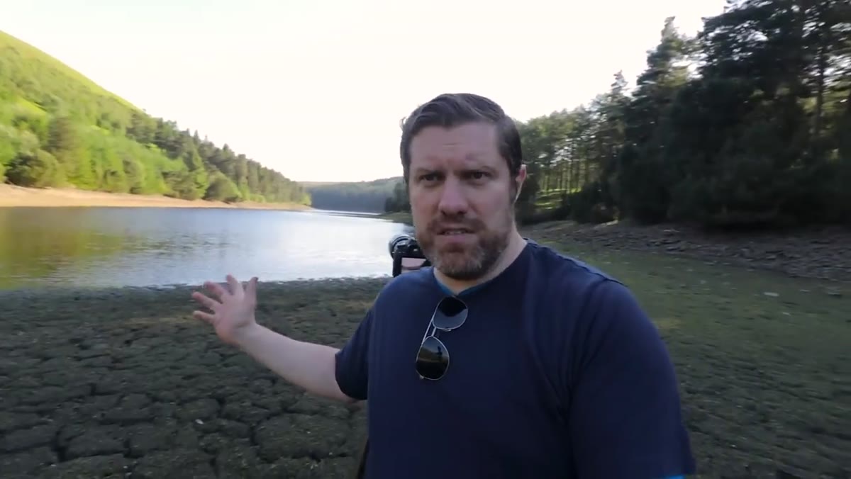 Wide shot showing wind-driven ripples moving across the reservoir surface