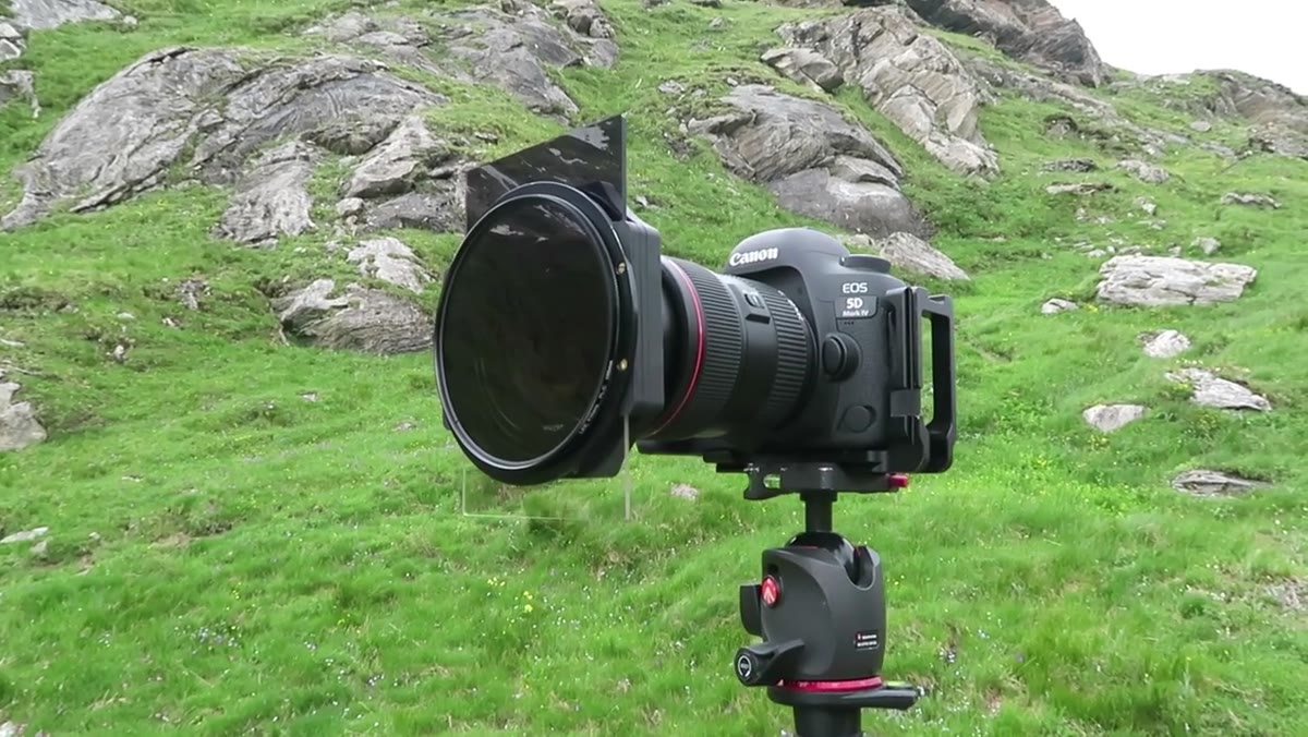 Camera on tripod aimed down valley, polarizer and grad filter attached