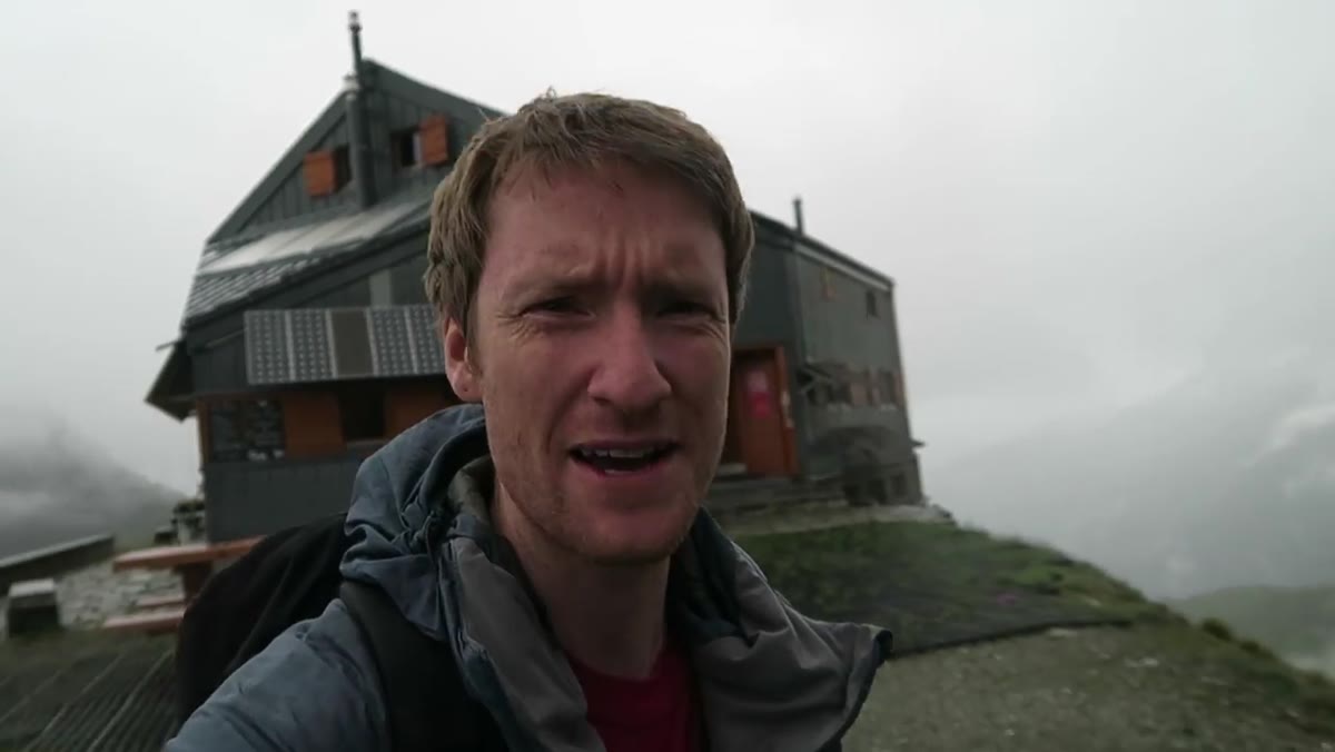 Mountain hut visible in background, glacier stretching behind it