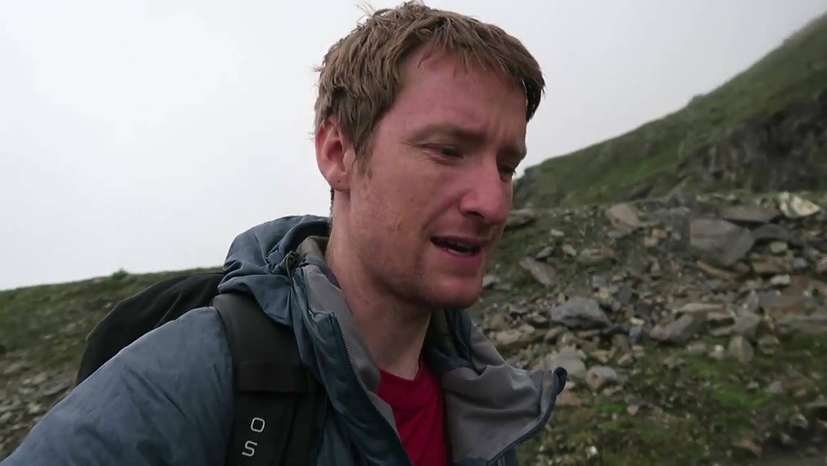 Low cloud and rain obscuring alpine peaks above the hut