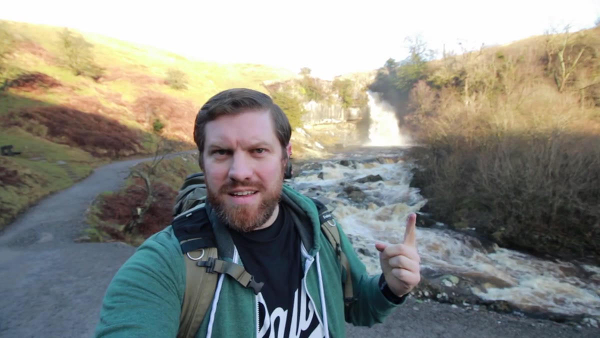Creator at the main falls, explaining spray and contrast problems