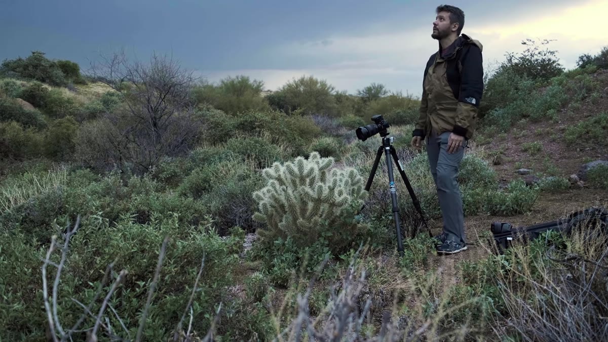 caption: Mark looking through viewfinder discussing what to include or exclude
