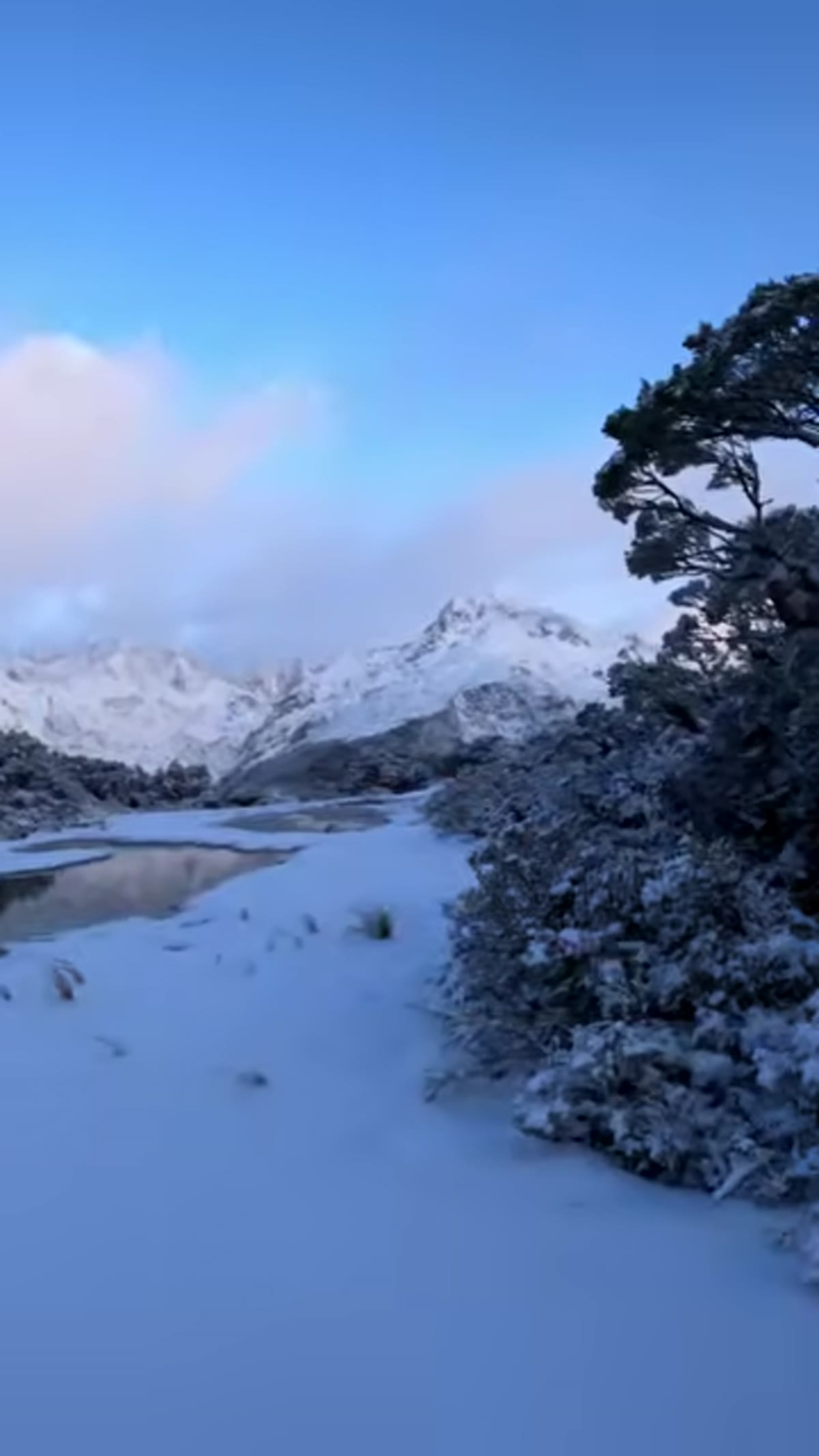 Alpenglow or storm light reflecting across mountain lakes