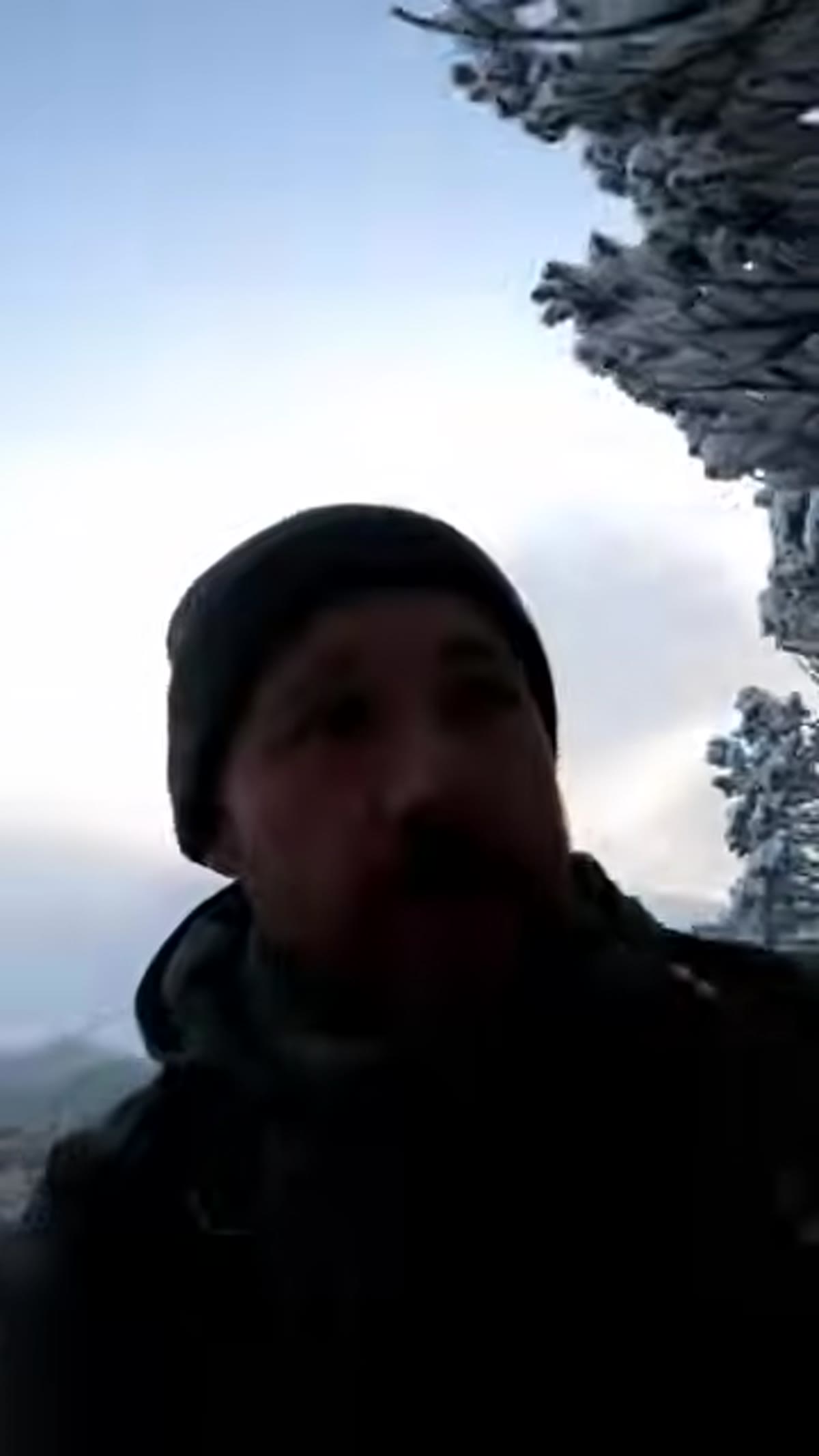 Photographer entering a snow-covered forest with icicles visible
