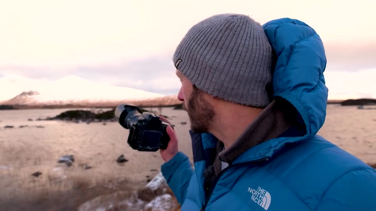 Telephoto lens mounted on camera, aimed at mountain detail