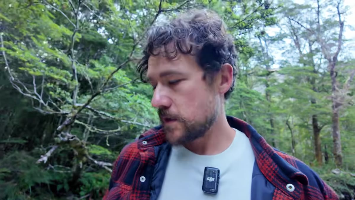 Photographer discovering higher cascade with more volume and moss further upstream