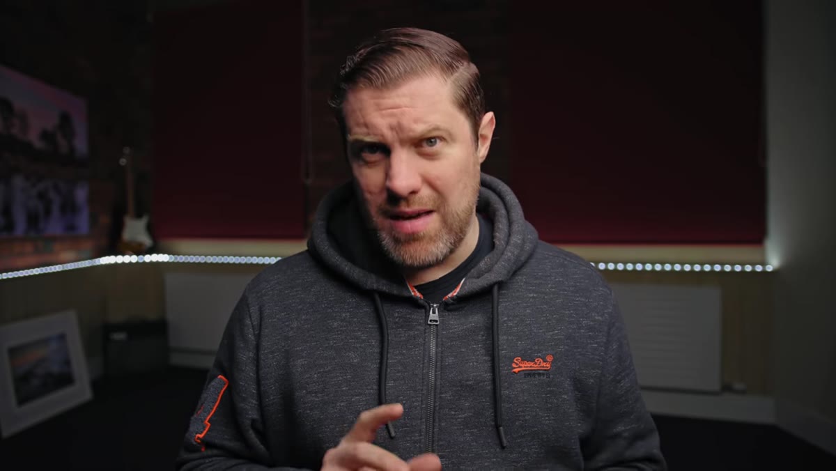 Creator holding camera and discussing gear relevance