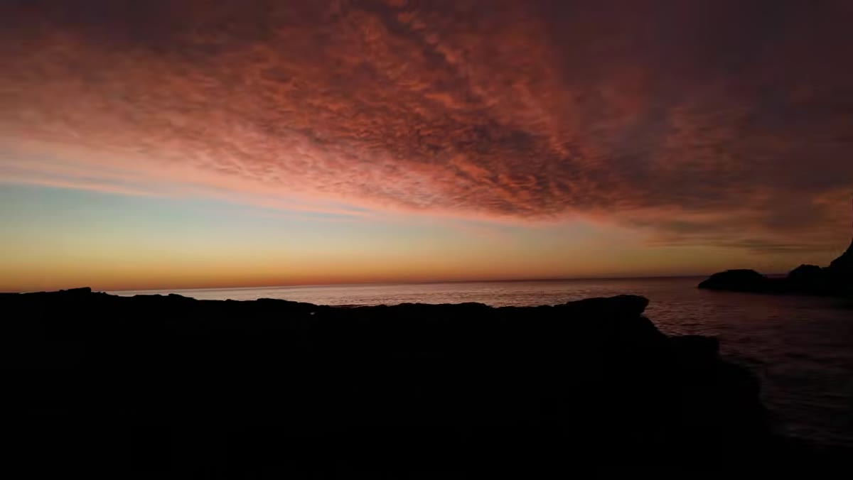 Sky beginning to color as sun approaches horizon