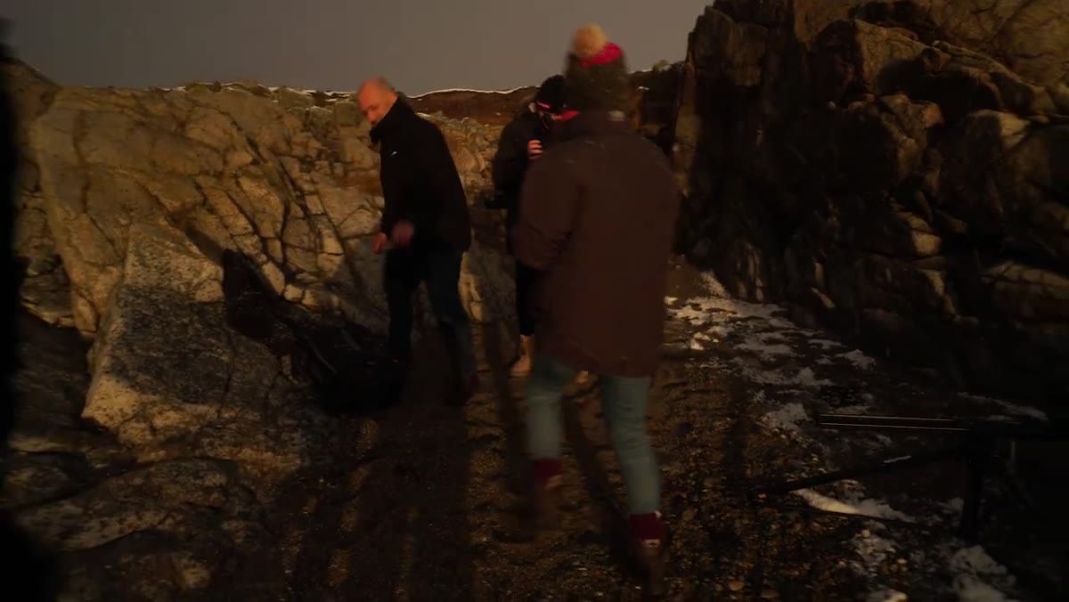 Photographer reacting with visible frustration as blizzard rolls in again