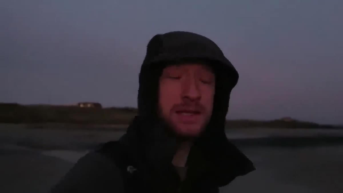 Heaton walking the beach in pre-dawn darkness