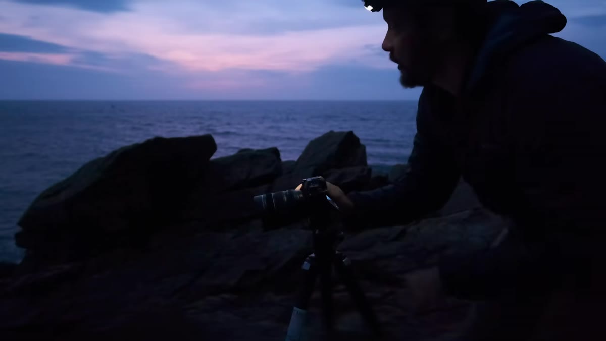 Pre-sunrise sky with color building over coastline