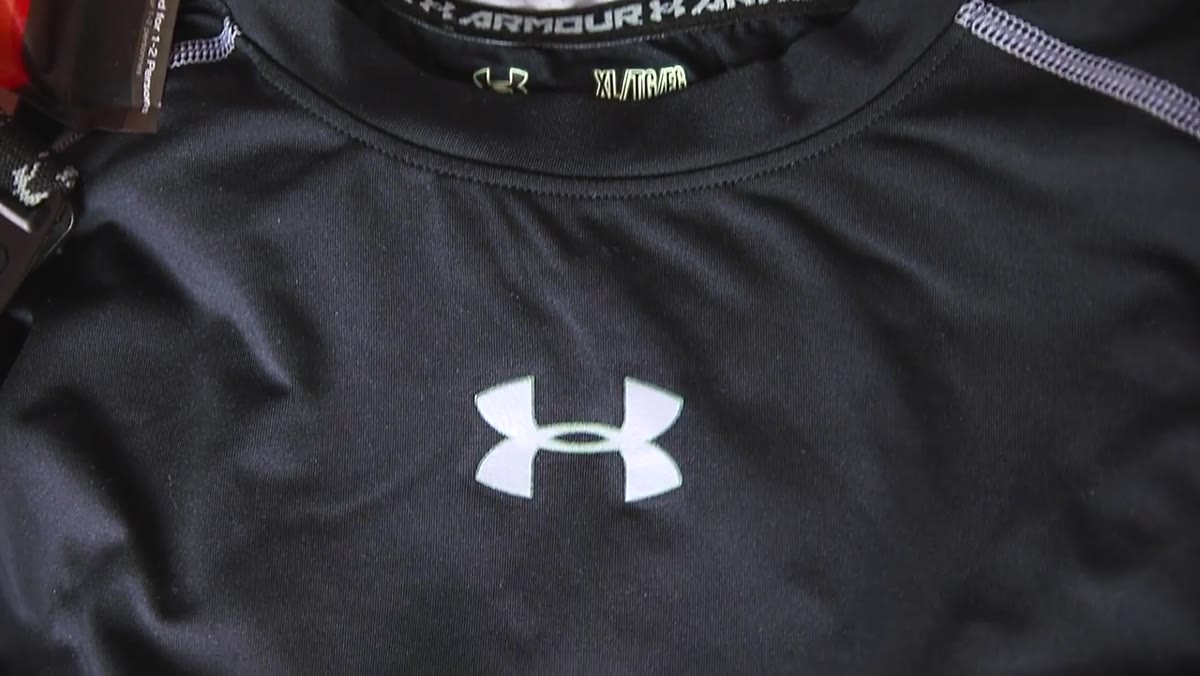 Holding up an Under Armour moisture-wicking base layer shirt