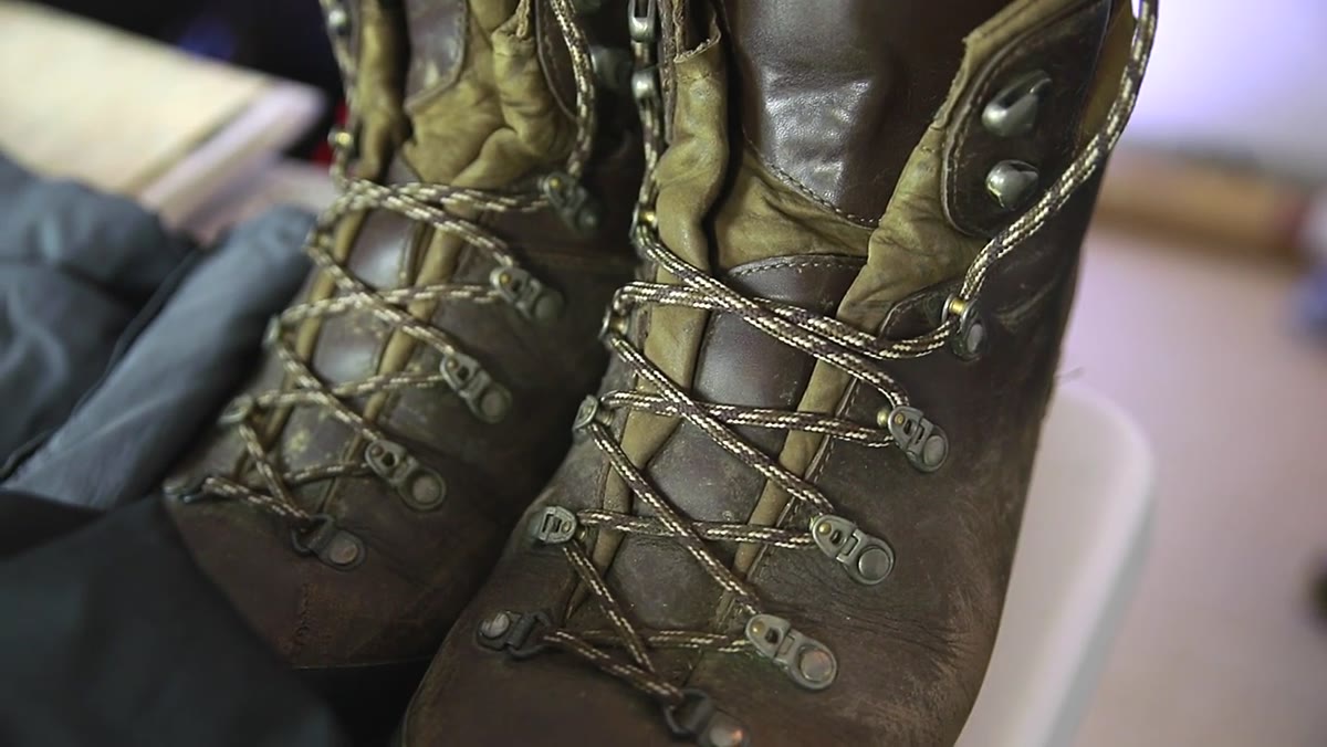 Holding up Scarpa waterproof hiking boots with sealed tongue