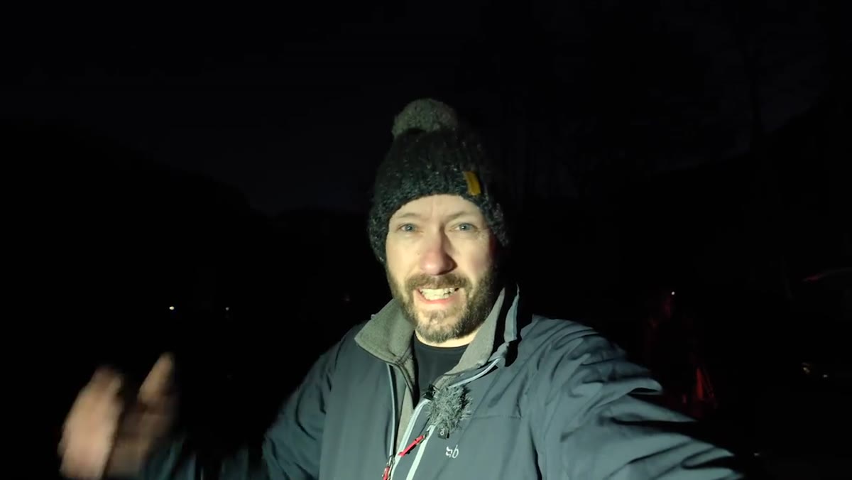Nigel addressing camera at 7am with stars still visible above the valley
