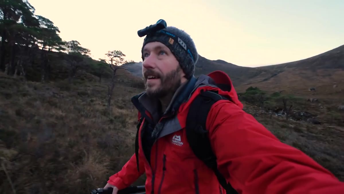 Nigel leaving the river location to climb higher toward alpenglow on the mountain